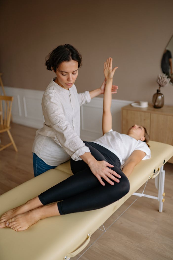 The Art of Drawing Readers In: Your attractive post title goes here Physiotherapist aids woman with therapeutic exercises indoors.